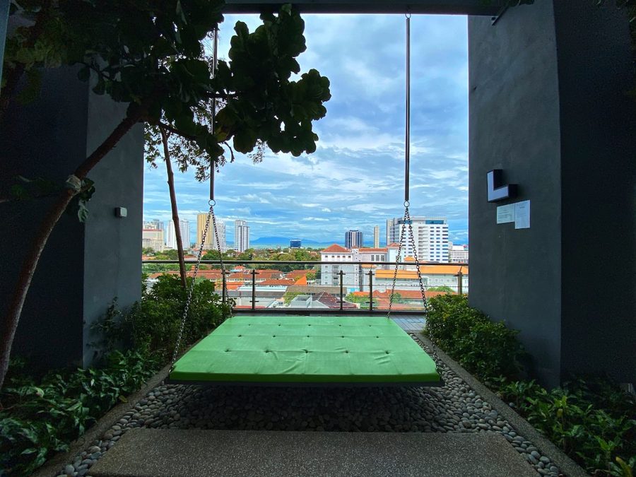 Sky garden with a net hammock and city view