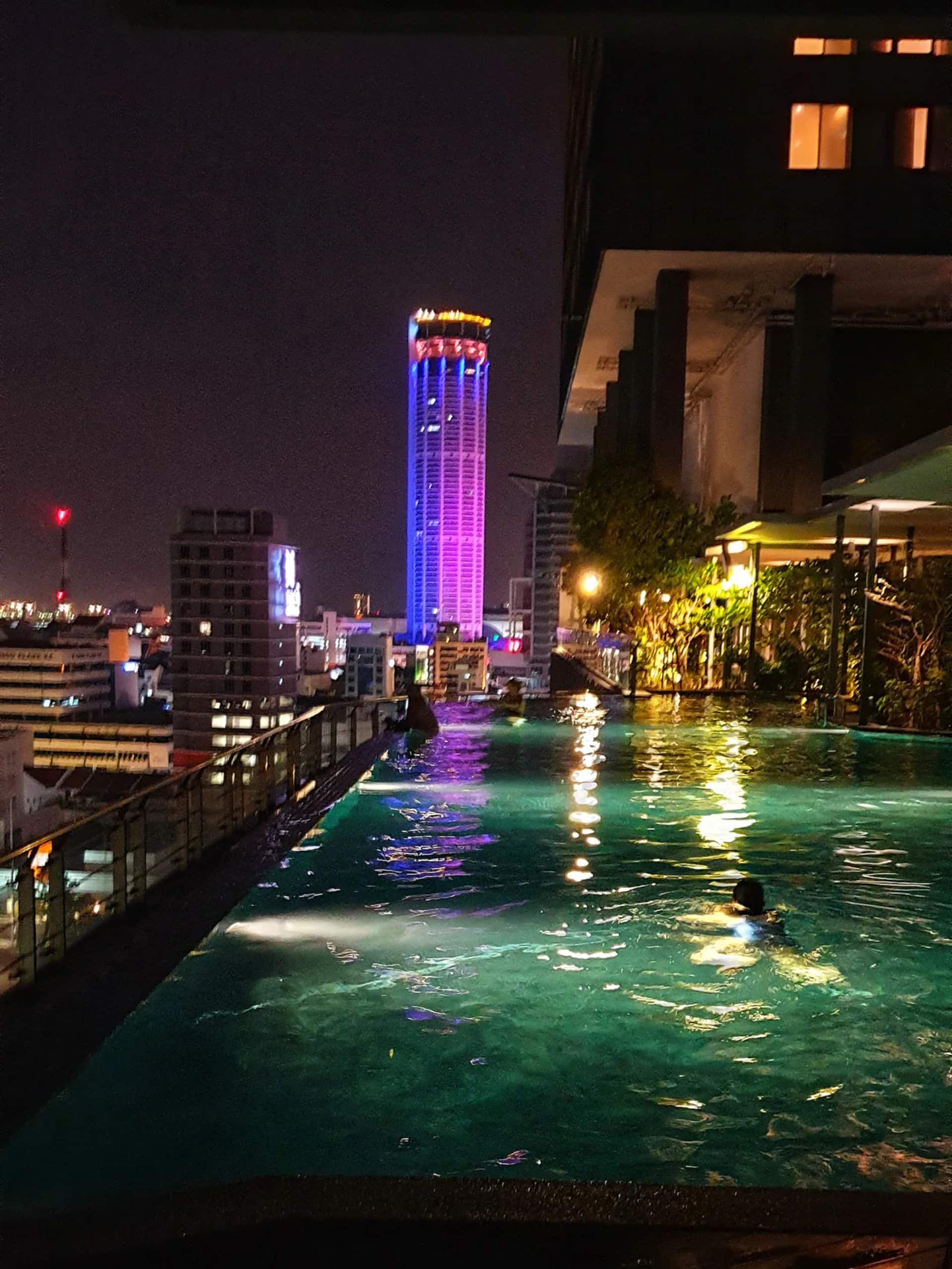Rooftop pool at night with KOMTAR tower lit up